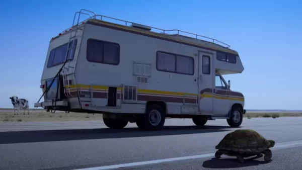 A still from the new Sonic Racing: CrossWorlds ad featuring a tortoise and an old RV with a TV strapped to its rear end